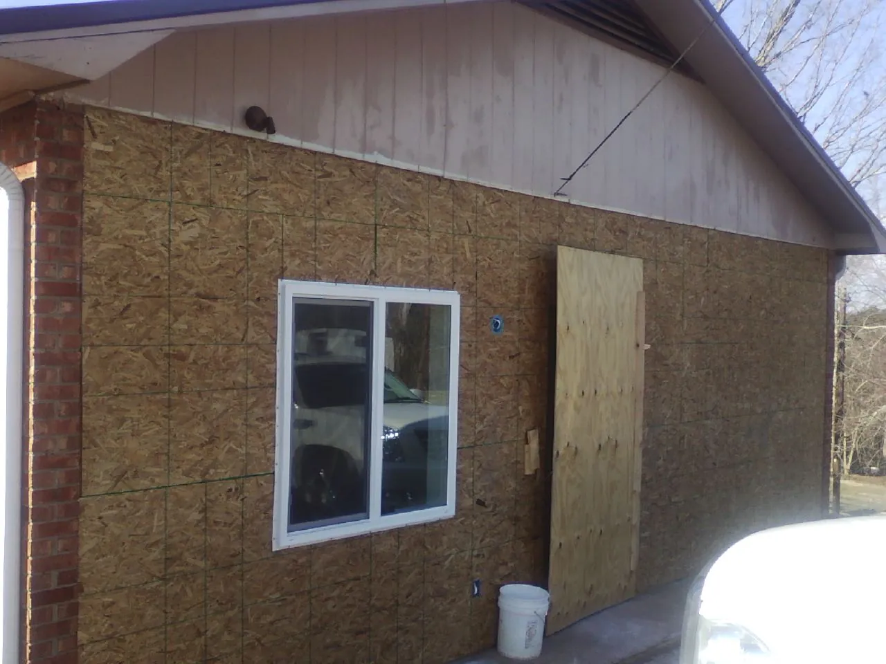 OSB sheathing on a garage addition wall before siding in Annandale